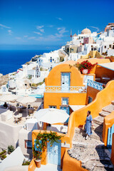 Young woman in Oia village in Santorini