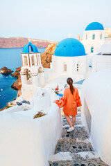 Beautiful girl in Oia village on Santorini island