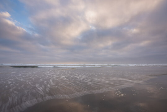 Peaceful and calming soft light pastel beach sunset on the Oregon Coast 