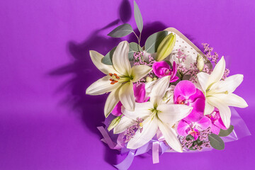 A beautiful bouquet of fresh flowers on a violet background