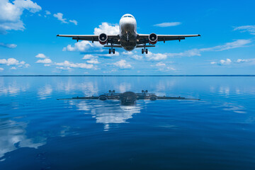 Flight of the plane above the calm water surface of the lake.