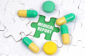 There are pills and vitamins on the white puzzles. Inside on a green background the inscription - MEDICAL REPORT