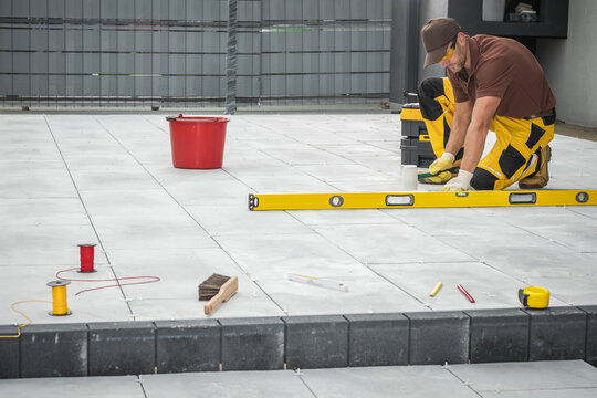 Outdoor Patio Tiles Installation by Professional Worker