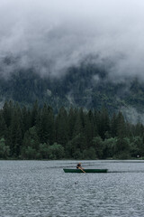 HINTERSEE, GERMANY, 3 AUGUST 2020: Lonely boat sailing in the foggy Intersee Lake in Bavaria