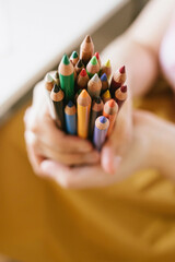 a bunch of colour pencils tips up on yellow background, positive concept of back to school and creativity - 452212789
