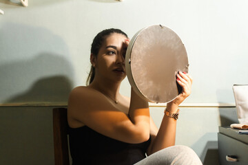 Naklejka premium Girl wiping her face to start making up in her room.
