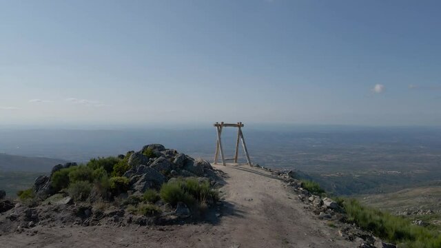 Farao swing sits on a mountaintop overlooking the valley below Folgosinho.