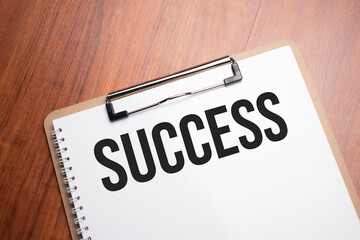 success text on white paper on the wood table