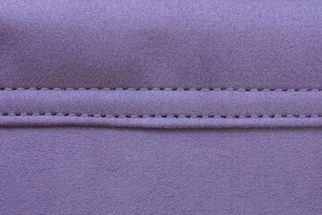 purple texture from a piece of suede with a seam on the bag