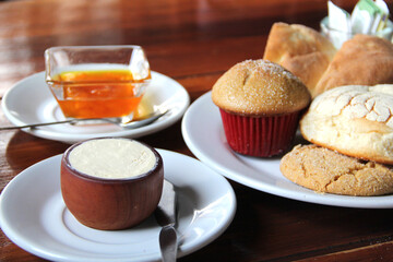 Delicious Mexican breakfast with coffee, sweet bread, beans, chilaquiles, butter, jam, sugar, fried egg, omelette
