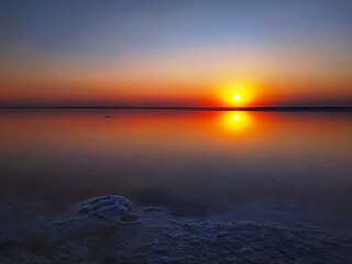 Colorful sunset on pink lake in Ukraine. The area of salt extraction for healthy cosmetic.