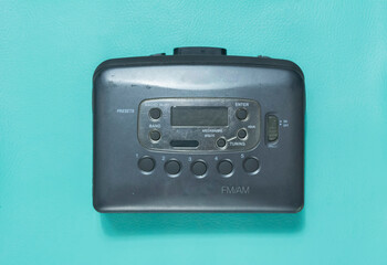 photo of portable cassette player isolated in turquoise background..