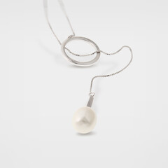 Silver pearl hoop necklace on white background