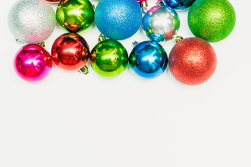 Christmas composition with colorful balls ornament, new year decorations on white background. Mockup greetings card template with copy space, flatly, top view