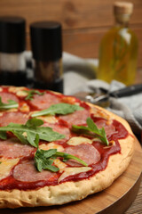 Delicious homemade pita pizza on wooden board, closeup