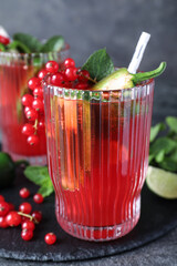 Glasses of spicy red currant cocktail with jalapeno and mint on grey table, closeup