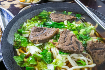 Taiwan beef noodle, a close up of Taiwanese tradition seasoned soup beef noodles with vegetable in food restaurant.