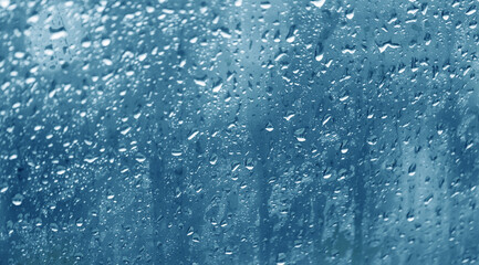 Condensation on the clear glass window. Water drops. Rain. Abstract background texture