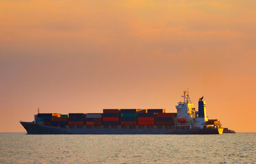 Container ship carrying container box in import export with quay crane, Global business cargo...