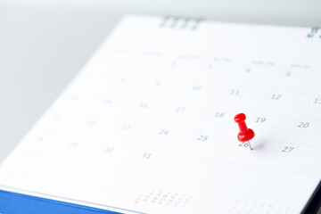 Thumbtack in calendar concept for busy, appointment and meeting reminder, planning for business meeting or travel planning concept.