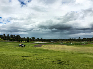 Fototapeta premium golf course with sky and clouds