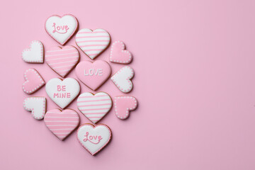 Delicious heart shaped cookies on pink background, flat lay. Space for text