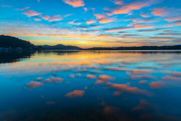 Fototapeta premium Sunrise waterscape with high cloud and reflections