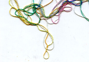Multicolor tangled color needlecraft silk cord. Abstract color background, in white background