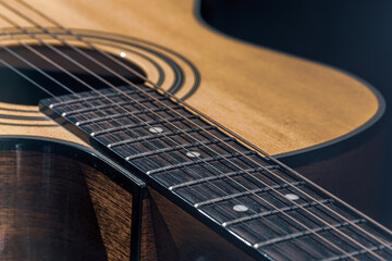 Obraz premium Close-up of a classical acoustic guitar in beautiful lighting.