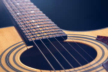 Obraz premium Close-up of a guitar fretboard on a blurred background.