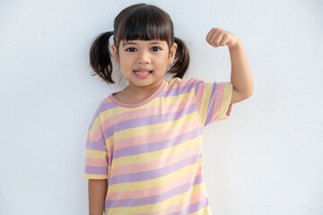 Happy Asian children showing her strong hands
