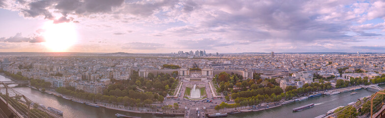A panoramic sunset view of Paris, centered on the Jardins de Trocadero and Palais de Chaillot, with...