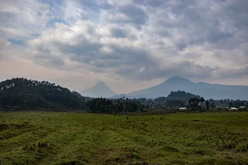 Foto op Canvas A wide, landscape shot of a moody, scenic, and cloudy landscape in Rwanda © Jaden