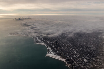 Wide aerial, high angle shot of the city of Chicago in the winter with buildings poking through the...