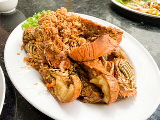 Deep fried Mantis shrimp with garlic and pepper in white plate.