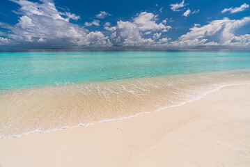Paradise white sand beach and turquoise water in nice summer day, Gulhi Island, Maldives