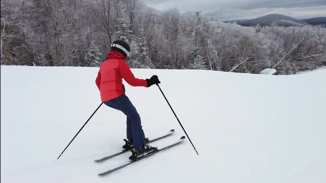 Skiing Downhill. Alpine ski in snow. Woman athlete riding slope trail. Mont Tremblant, Quebec, Canada