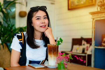 Portrait of a beautiful Asian woman sitting in a bakery