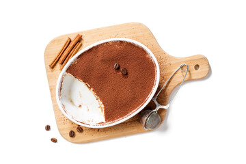 Classic Italian Dessert Tiramisu topped with cocoa  in a ceramic dish. Isolated on white background, top view