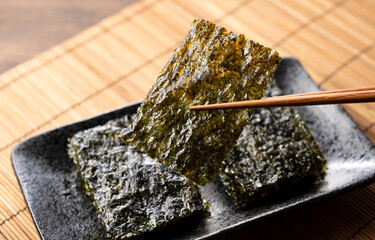 Korean seaweed on a wooden table. Asian food. © m________k____