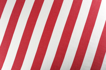Striped beach towel as background, top view