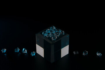 diamonds on a glass cube on a dark background