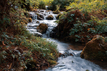 Naklejka na ściany i meble Waterfalls and rapids of a mountain stream
