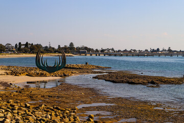 Kurnell National Park Sculpture on the rocky foreshore with the bay in the background. No people,...
