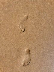 Footprints left in the sand on the beach, by a person