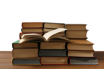Many books on wooden table against white background. Library material