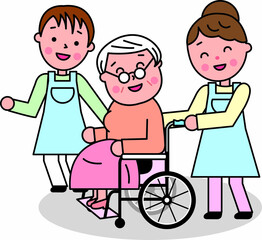 高齢女性が乗る車椅子に寄り添う介護の男女