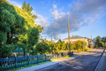 The fence of the Kremlin garden and a deserted street in Vologda