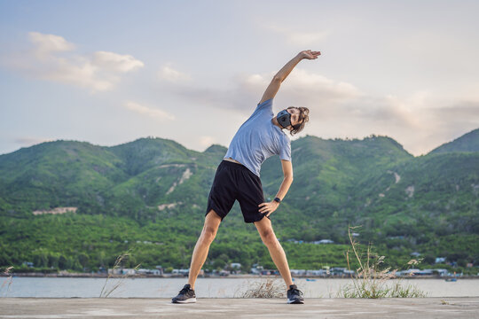 Runner wearing medical mask, Coronavirus pandemic Covid-19. Sport, Active life in quarantine surgical sterilizing face mask protection. Outdoor run on athletics track in Corona Outbreak - Powered by Adobe