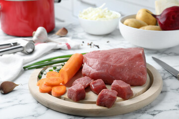Fresh ingredients for borscht on white marble table